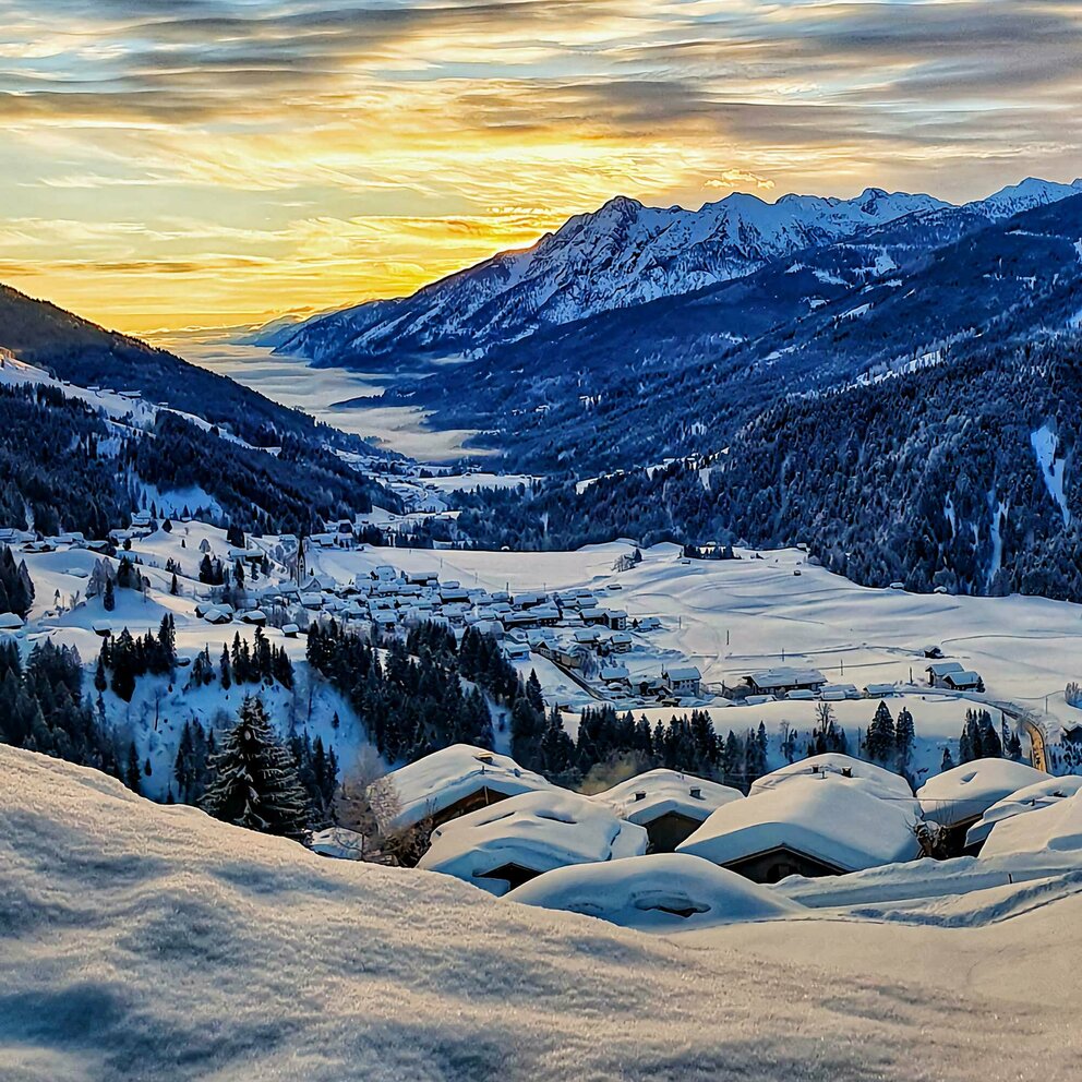 Winterliche Sonnenaufgangsstimmung beim Blick ins verschneite Lesachtal.