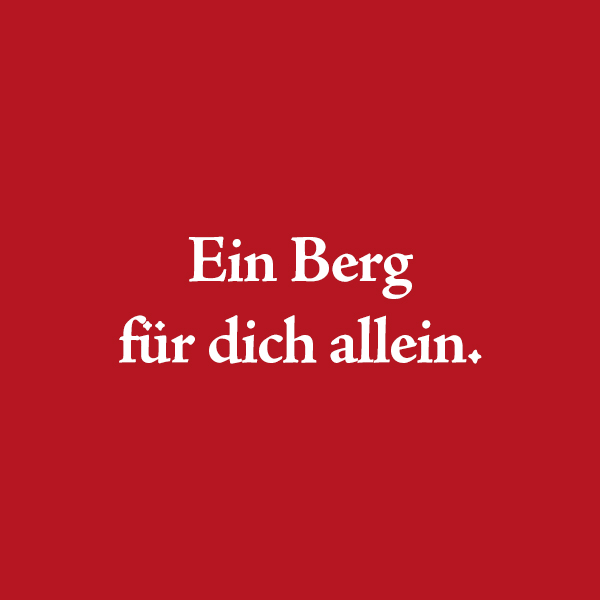 Roter Hintergrund mit dem weißen Schriftzug "Ein Berg für dich allein"